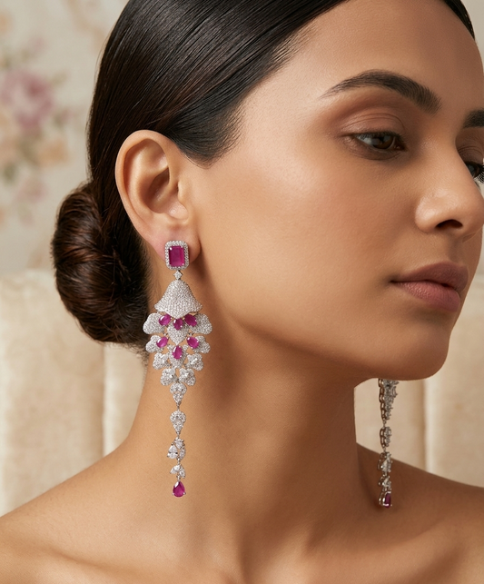 Close-up of a woman wearing elegant earrings with gemstones.