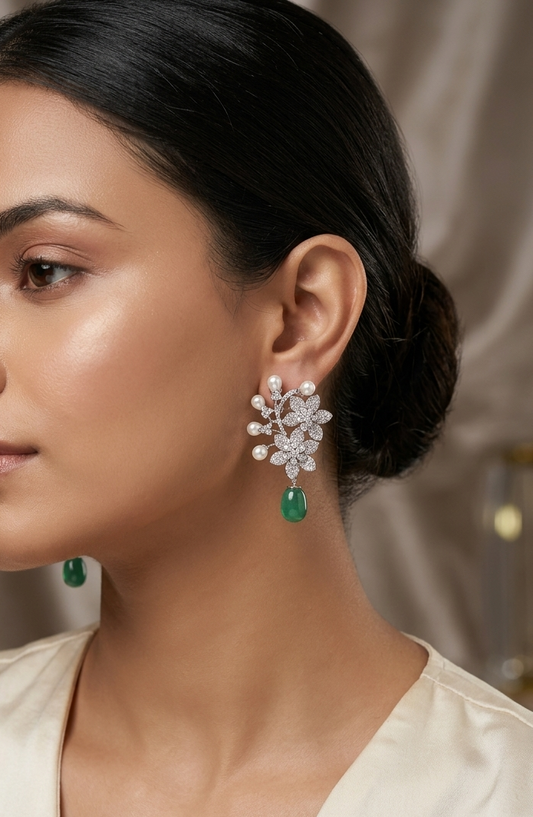 Close-up of a woman wearing elegant earrings with a neutral background