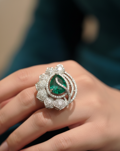 Luxury emerald and diamond ring on a hand with a blurred background