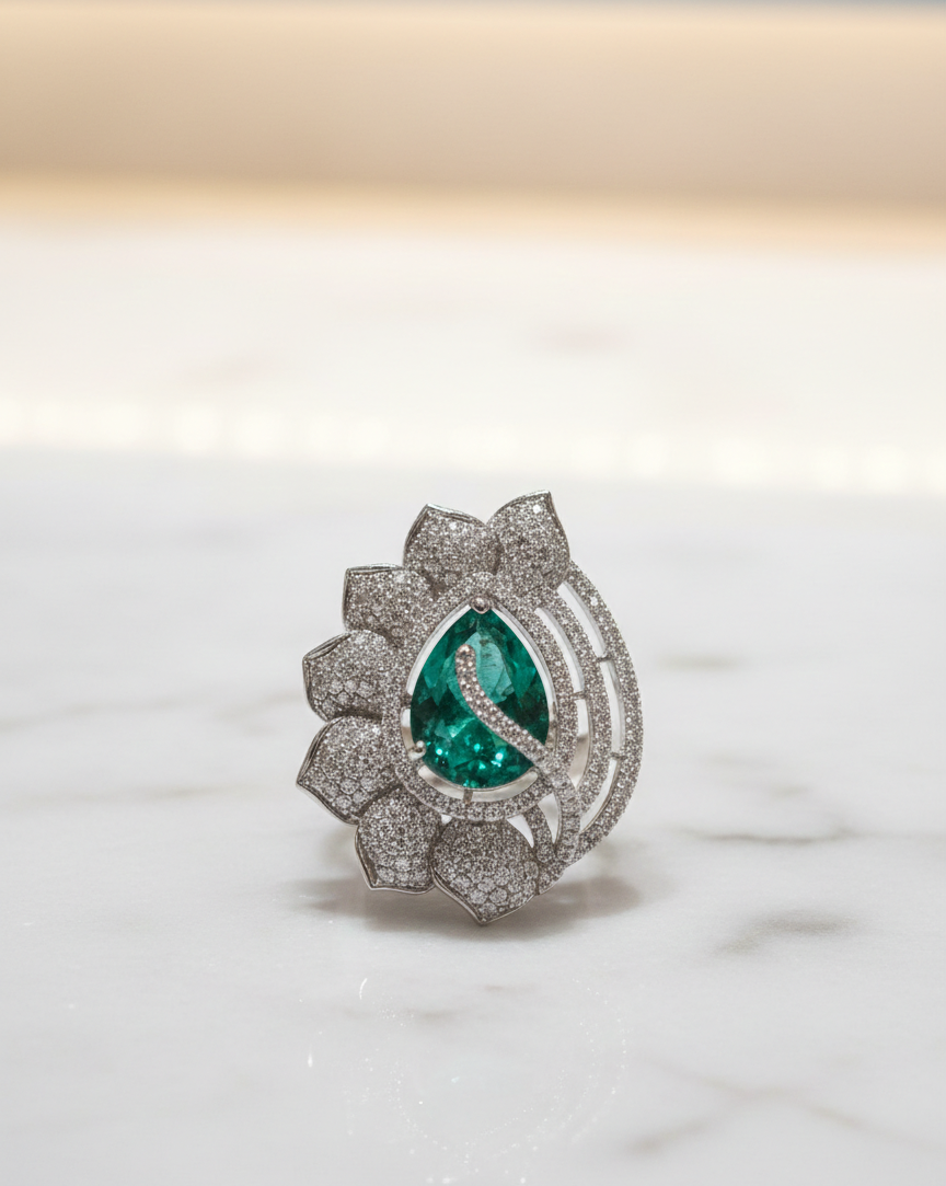 Luxury ring with emerald and diamond design on a white background
